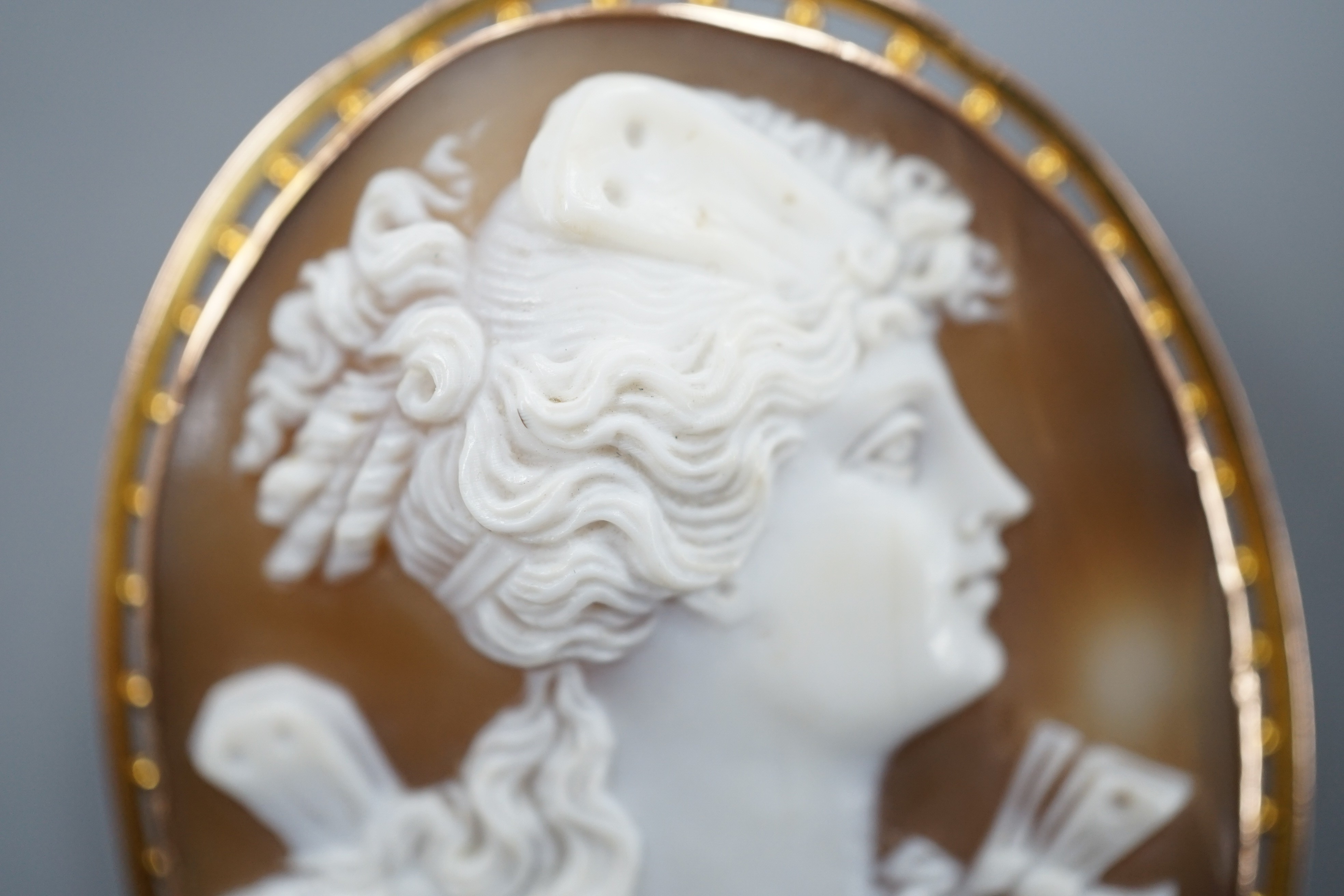 A 9ct mounted oval cameo shell brooch, carved with the bust of a lady to sinister, 5cm, gross weight 11.8 grams.